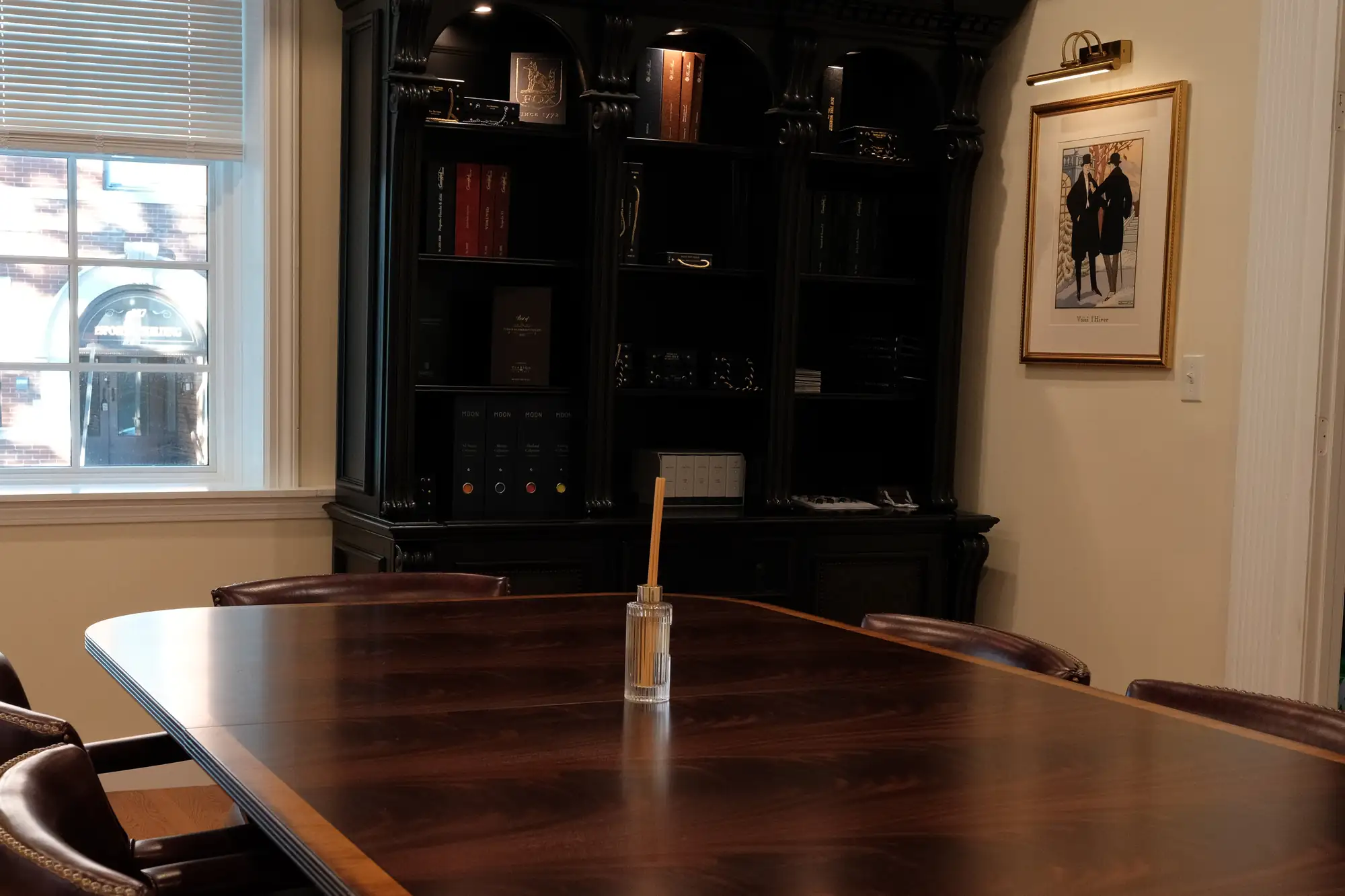 The fitting room at 528 Chapel Street: a mahogany table, leather chairs and the cabinet of cloth books